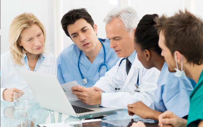 Health Professions Education Online Graduate Certificate Image of Doctors, Nurses, and Staff Learning Together