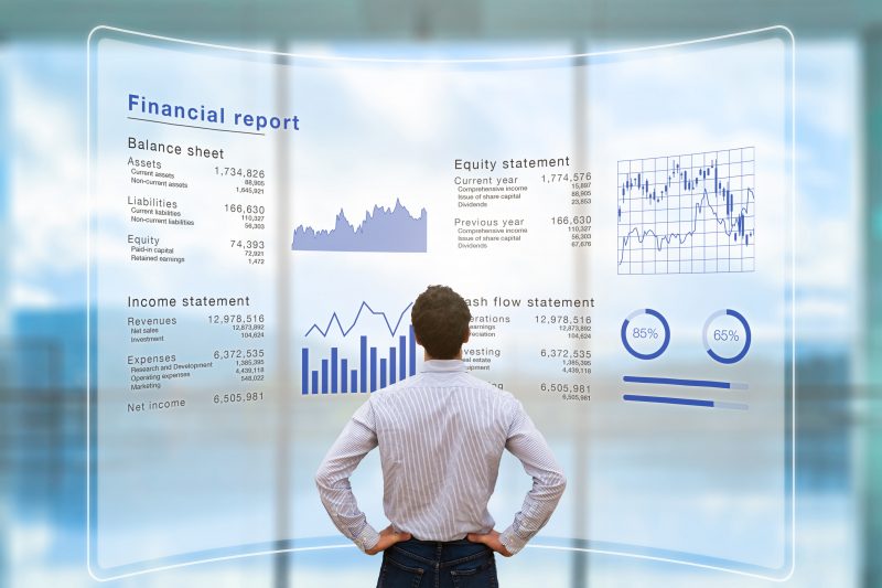 Accounting Analytics Online Graduate Certificate Image of Analyst Looking Over Reports on a Presentation Screen