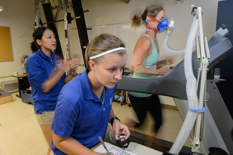 Exercise Prescription Online Graduate Certificate Image of Exercise Physiologists Testing Athlete using Monitoring Equipment