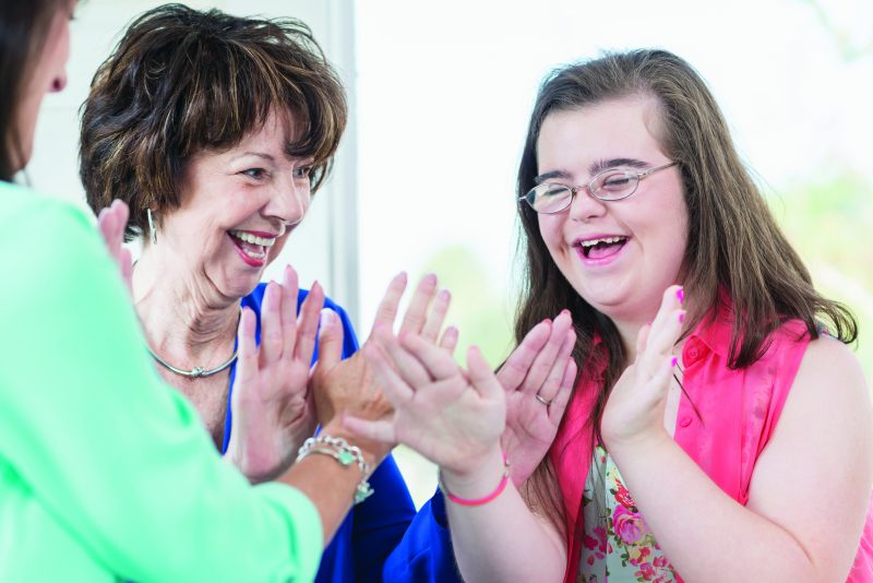 Special Education Transition to Adulthood Online Graduate Certificate Disability Instructor and Parent Working with Teenager with Down Syndrome
