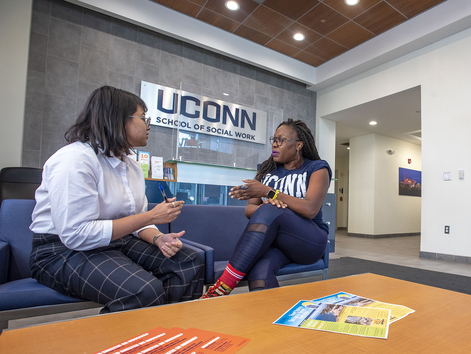 Ph.D. students having a conversation in the entryway of the School of Social Work.