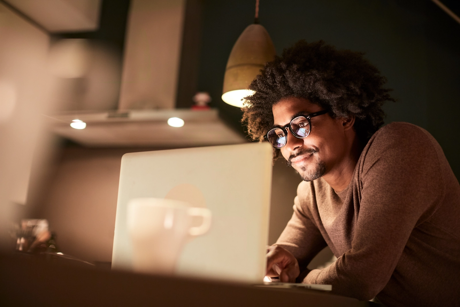 Male African American student looking at laptop, University of Connecticut Graduate Certificate - Online Master's Programs